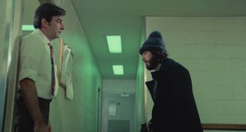 Movie still from “Serpico” (1973), directed by Sidney Lumet – Two men in a hallway looking at each other; Medium shot, Low angle