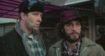 Movie still from “Serpico” (1973), directed by Sidney Lumet – A couple of men standing next to each other; Close Up shot, Low angle