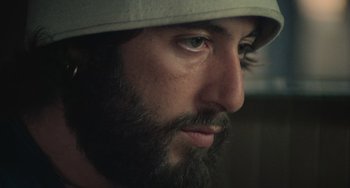 Movie still from “Serpico” (1973), directed by Sidney Lumet – A person with a beard wearing a hat; Close Up shot, Low angle