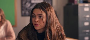 Movie still from “Sex Appeal” (2022), directed by Talia Osteen – A person with long brown hair; Close Up shot, Over the shoulder angle