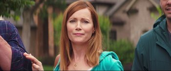 Movie still from “Blockers” (2018), directed by Kay Cannon – A person with long red hair; Close Up shot, Over the shoulder angle
