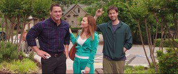 Movie still from “Blockers” (2018), directed by Kay Cannon – Three people standing next to each other on the sidewalk; Medium shot, Over the shoulder angle