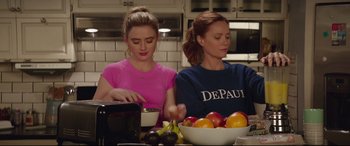 Movie still from “Blockers” (2018), directed by Kay Cannon – Two young women are preparing a meal in the kitchen; Medium shot, Over the shoulder angle