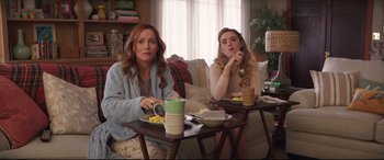 Movie still from “Blockers” (2018), directed by Kay Cannon – Two women sitting at a table with plates of food in front of them; Medium shot, Over the shoulder angle