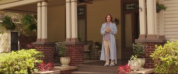 Movie still from “Blockers” (2018), directed by Kay Cannon – A woman standing on the porch of a house; Wide shot, Low angle