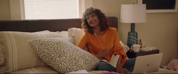 Movie still from “Blockers” (2018), directed by Kay Cannon – A woman sitting on a bed listening to music; Medium shot, Over the shoulder angle