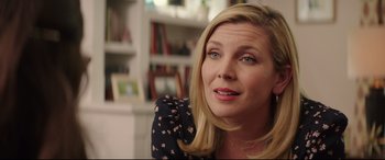 Movie still from “Blockers” (2018), directed by Kay Cannon – A person sitting in a room; Close Up shot, Over the shoulder angle