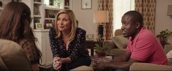 Movie still from “Blockers” (2018), directed by Kay Cannon – A woman sitting on the ground in a living room; Medium shot, Over the shoulder angle