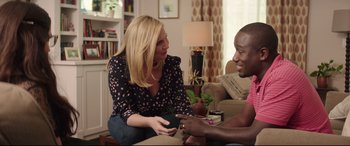 Movie still from “Blockers” (2018), directed by Kay Cannon – A woman sitting next to a man in a living room; Medium shot, Over the shoulder angle