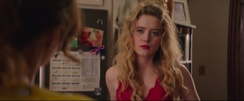 Movie still from “Blockers” (2018), directed by Kay Cannon – A woman with long blonde hair wearing a red top; Close Up shot, Over the shoulder angle