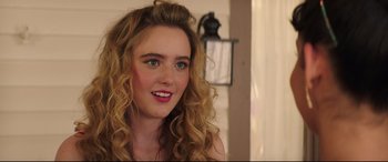 Movie still from “Blockers” (2018), directed by Kay Cannon – A person with curly hair; Close Up shot, Over the shoulder angle