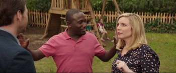 Movie still from “Blockers” (2018), directed by Kay Cannon – A man and a woman talking in a yard; Medium shot, Over the shoulder angle