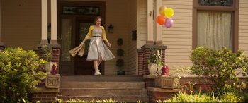Movie still from “Blockers” (2018), directed by Kay Cannon – A woman is walking down the steps of a house; Wide shot, Low angle