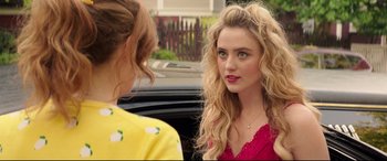 Movie still from “Blockers” (2018), directed by Kay Cannon – Two young women talking to each other in front of a black car; Close Up shot, Over the shoulder angle