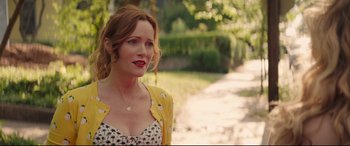 Movie still from “Blockers” (2018), directed by Kay Cannon – A woman with red hair wearing a yellow jacket; Close Up shot, Over the shoulder angle