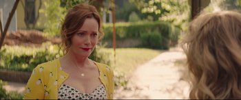 Movie still from “Blockers” (2018), directed by Kay Cannon – A person standing on a sidewalk; Close Up shot, Over the shoulder angle