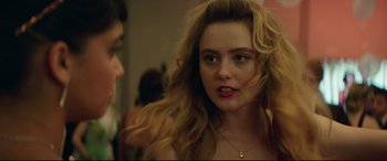Movie still from “Blockers” (2018), directed by Kay Cannon – A woman with long blonde curly hair and green eyes; Close Up shot, Over the shoulder angle