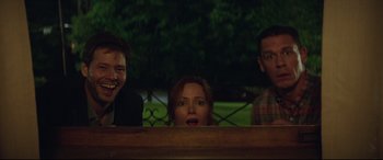 Movie still from “Blockers” (2018), directed by Kay Cannon – A group of people standing next to each other on a bench; Medium shot, Low angle