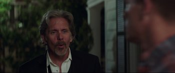 Movie still from “Blockers” (2018), directed by Kay Cannon – A person wearing a suit and tie; Close Up shot, Over the shoulder angle