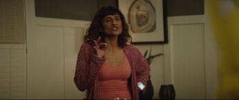 Movie still from “Blockers” (2018), directed by Kay Cannon – A woman in a pink shirt is giving a speech; Medium shot, Over the shoulder angle