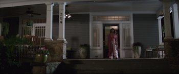 Movie still from “Blockers” (2018), directed by Kay Cannon – A woman standing on the porch of a house; Wide shot, Low angle