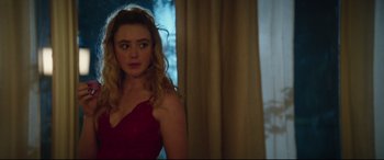 Movie still from “Blockers” (2018), directed by Kay Cannon – A woman in a red dress standing in front of a window; Medium shot, Over the shoulder angle