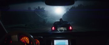 Movie still from “Blockers” (2018), directed by Kay Cannon – A car driving down a road in the dark; Extreme Wide shot, Over the shoulder angle