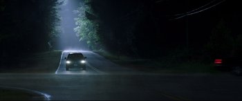 Movie still from “Blockers” (2018), directed by Kay Cannon – A car driving down a street at night; Extreme Wide shot, Low angle