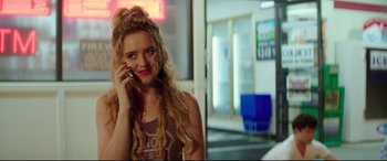 Movie still from “Blockers” (2018), directed by Kay Cannon – A woman talking on a cell phone in a room; Close Up shot, Over the shoulder angle