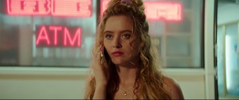 Movie still from “Blockers” (2018), directed by Kay Cannon – A woman with long blonde curly hair is talking on a cell phone; Close Up shot, Low angle