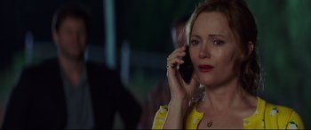 Movie still from “Blockers” (2018), directed by Kay Cannon – A woman talking on a cell phone while wearing a yellow jacket; Close Up shot, Over the shoulder angle
