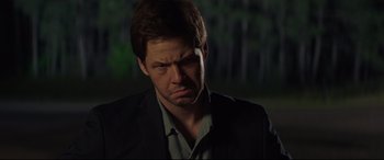 Movie still from “Blockers” (2018), directed by Kay Cannon – A person wearing a suit and tie; Close Up shot, Over the shoulder angle