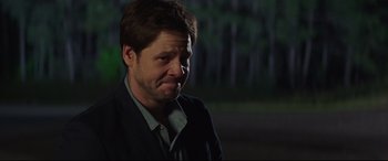 Movie still from “Blockers” (2018), directed by Kay Cannon – A person wearing a suit and tie; Close Up shot, Over the shoulder angle