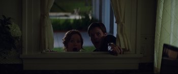 Movie still from “Blockers” (2018), directed by Kay Cannon – A man and a woman looking surprised at something; Medium shot, Low angle