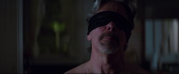 Movie still from “Blockers” (2018), directed by Kay Cannon – A person wearing a blindfold; Close Up shot, Over the shoulder angle