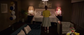 Movie still from “Blockers” (2018), directed by Kay Cannon – A woman standing in front of a bed in a bedroom; Wide shot, Over the shoulder angle