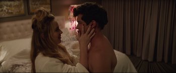 Movie still from “Blockers” (2018), directed by Kay Cannon – A man and a woman in a bed with one hand on the other's face; Medium shot, Overhead angle