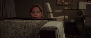 Movie still from “Blockers” (2018), directed by Kay Cannon – A woman sitting on a couch looking at the camera; Medium shot, Over the shoulder angle