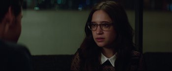 Movie still from “Blockers” (2018), directed by Kay Cannon – A young woman wearing glasses and a black shirt; Close Up shot, Over the shoulder angle
