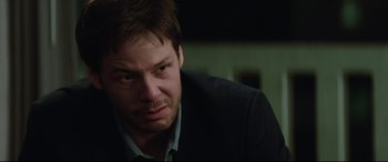 Movie still from “Blockers” (2018), directed by Kay Cannon – A person wearing a suit and tie; Close Up shot, Over the shoulder angle