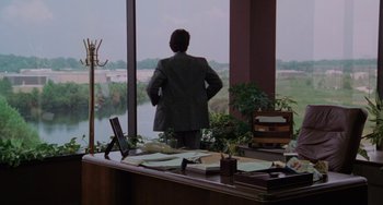 Movie still from “Sex, Lies, and Videotape” (1989), directed by Steven Soderbergh – A man standing in front of a large window; Extreme Wide shot, Over the shoulder angle