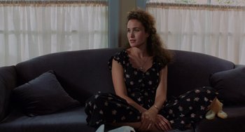 Movie still from “Sex, Lies, and Videotape” (1989), directed by Steven Soderbergh – A woman sitting on top of a couch in a living room; Medium shot, High angle