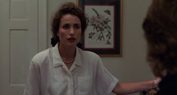 Movie still from “Sex, Lies, and Videotape” (1989), directed by Steven Soderbergh – A woman wearing a white shirt and a necklace; Medium shot, Over the shoulder angle