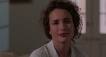 Movie still from “Sex, Lies, and Videotape” (1989), directed by Steven Soderbergh – A person with curly hair wearing a white shirt; Close Up shot, Over the shoulder angle