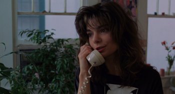 Movie still from “Sex, Lies, and Videotape” (1989), directed by Steven Soderbergh – A woman is talking on a phone while sitting in a room; Close Up shot, High angle