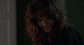 Movie still from “Sex, Lies, and Videotape” (1989), directed by Steven Soderbergh – A person with a smile on their face; Close Up shot, Over the shoulder angle
