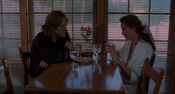 Movie still from “Sex, Lies, and Videotape” (1989), directed by Steven Soderbergh – Two women sitting at a table with wine glasses; Medium shot, Over the shoulder angle