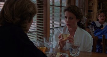 Movie still from “Sex, Lies, and Videotape” (1989), directed by Steven Soderbergh – A woman sitting at a table holding a wine glass; Close Up shot, Over the shoulder angle