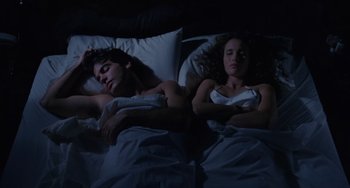 Movie still from “Sex, Lies, and Videotape” (1989), directed by Steven Soderbergh – A man and a woman sleeping in a bed at night; Medium shot, Overhead angle