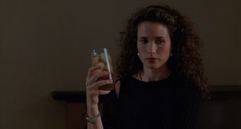 Movie still from “Sex, Lies, and Videotape” (1989), directed by Steven Soderbergh – A woman holding a glass in her hand; Close Up shot, High angle